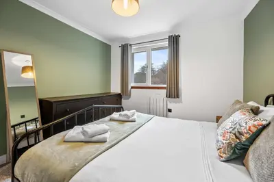 a bedroom with a bed with two towels on it at 2BR Oban Retreat with Free Parking in Oban