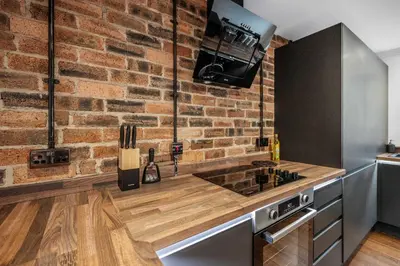 a kitchen with a brick wall and a counter top at 2BR Oban Retreat with Free Parking in Oban