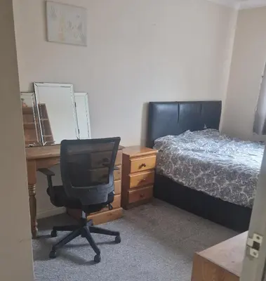 a bedroom with a desk and a bed and a chair at Victory Room in Moffat