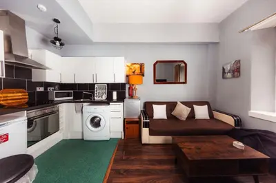 a small living room with a couch and a table at Calm, Cosy & Central Apartment near Meadows 10 in Edinburgh
