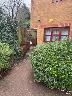 a brick house with a large bush in front of it at Peace Haven Hendon London NW4 in Moffat