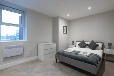 a white bedroom with a bed and a window at Chic 1Bed in Hull City Centre near Hull College in Moffat