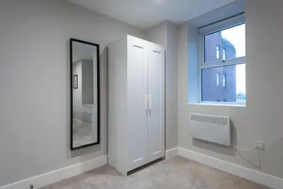 a white bathroom with a mirror and a window at Chic 1Bed in Hull City Centre near Hull College in Moffat