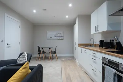 a kitchen and living room with a table and chairs at Chic 1Bed in Hull City Centre near Hull College in Moffat