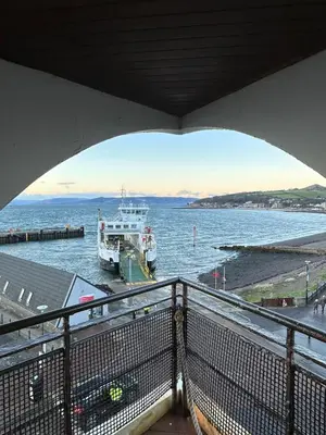 a boat in the water under a bridge at Seaside Penthouse in Largs