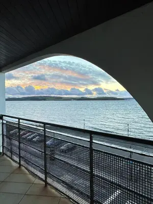 a view of the ocean from a balcony at Seaside Penthouse in Largs
