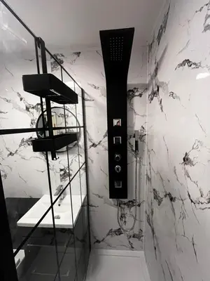 a bathroom with a black and white marble wall at Seaside Penthouse in Largs