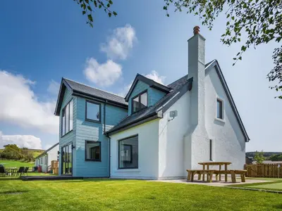 a house with a picnic table in front of it at A'chrannchuir in Blackwaterfoot