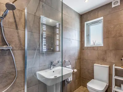 a bathroom with a shower and a sink and a toilet at A'chrannchuir in Blackwaterfoot