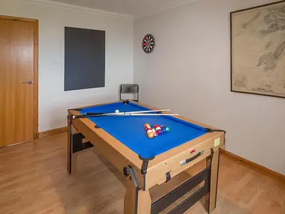 a pool table with balls on it in a room at Tanglewood in Whiting Bay