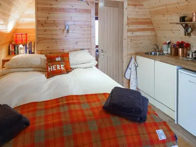 a bedroom with a bed in a log cabin at Here - Uk50566 in Port of Menteith