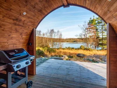 an arched doorway to a backyard with a grill at Here - Uk50566 in Port of Menteith