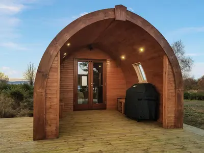 a small wooden building with an arch entrance at Now - Uk50567 in Port of Menteith