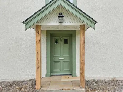 a green door with a light on top of it at Lady Farm in Girvan