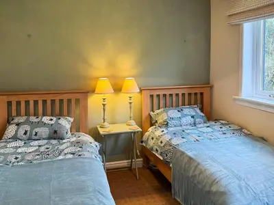 two beds sitting next to each other in a bedroom at The Green in Lochranza