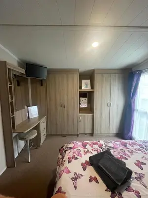 a bedroom with a bed and a desk at Shells at Sandylands in Stevenston