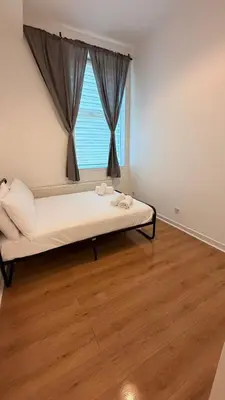 a bedroom with a bed in front of a window at Acorn Spacious Stay Glasgow in Glasgow