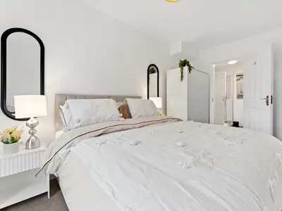 a white bedroom with a large white bed at Modern 2-Bedroom Apartment with Free Parking in Warrington in Moffat