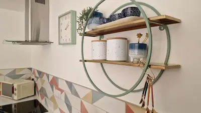 a round shelf with ceramics on a wall at Modern apartment on the river in Callander in Callander