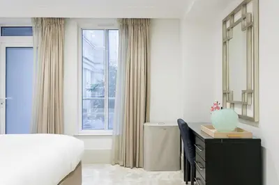 a bedroom with a bed and a desk and a window at Luxury 2BR Park Lane Apartment Mayfair Sleeps 6 PL15B in Moffat