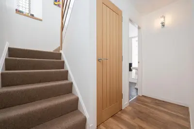 a hallway with stairs leading up to a door at Historic 1BR Home in Culross Near Filming Sites in Culross