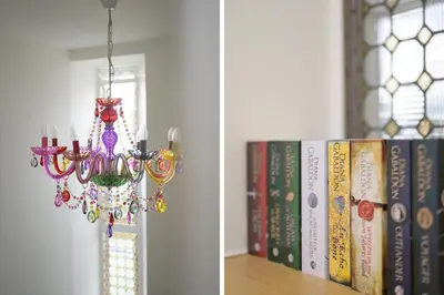 a chandelier hanging from a wall next to books at Historic 1BR Home in Culross Near Filming Sites in Culross