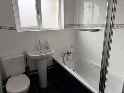 a bathroom with a toilet and a sink and a shower at Spacious Glasgow Group Stay in Glasgow