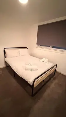 a bed with towels on it in a room at Spacious Glasgow Group Stay in Glasgow