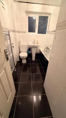 a bathroom with a toilet and a sink at Spacious Glasgow Group Stay in Glasgow