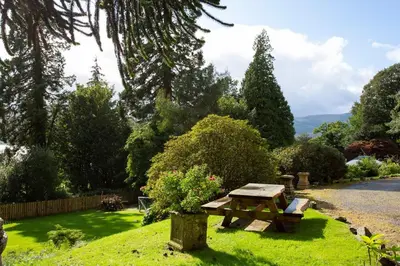 a picnic table in the grass in a garden at Old Argyll House in Rashfield