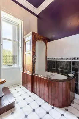 a large bathroom with a tub and a window at Argyll Country House in Clachan