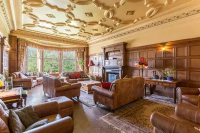 a living room with couches and a fireplace at Argyll Country House in Clachan