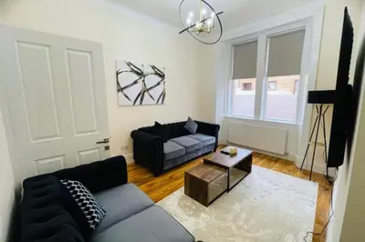 a living room with a couch and a table at Glasgow City View Retreat in Glasgow