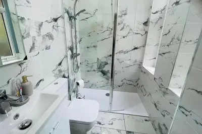 a bathroom with a shower and a sink and a toilet at Glasgow City View Retreat in Glasgow