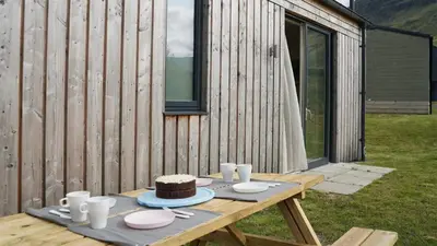 a picnic table with a cake on top of it at Auch - Cottages in Bridge of Orchy
