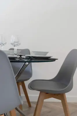 a table with two chairs and a table with wine glasses at Contractor & Family Friendly House - Sleeps 8 - FREE Parking and Fast Wi-Fi in Uphall