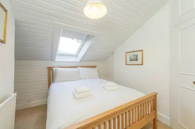 a bedroom with a bed in a attic at Top floor, central, spacious, period apartment with park views in Edinburgh