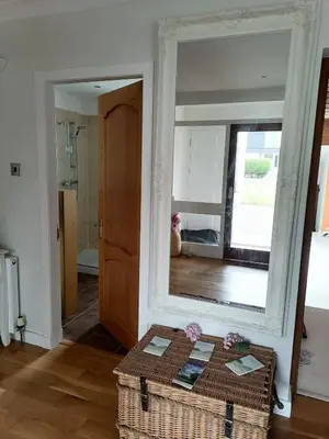 a mirror in a room with a table in front of it at King size bed Direct bus to city center Silver in Edinburgh