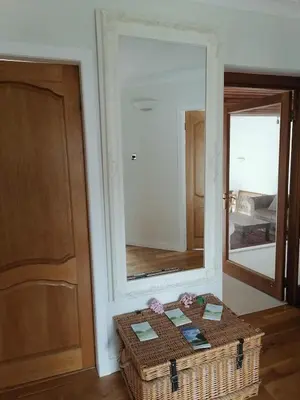 a room with a wickerasket in front of a mirror at King size bed Direct bus to city center Silver in Edinburgh