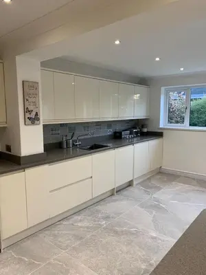 a large kitchen with white cabinets and a window at Fairway House- Stylish refurbished property in Moffat