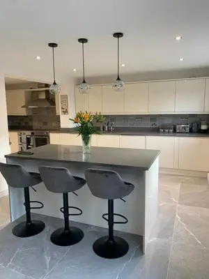 a kitchen with a large island with two bar stools at Fairway House- Stylish refurbished property in Moffat