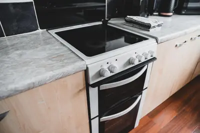 a kitchen with a black and white stove top oven at Glenraith property in Hogganfield