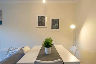 a dining room table with a potted plant on it at Tranquil 2 Bed Flat, Free Parking, near Murrayfield & City Centre in Edinburgh