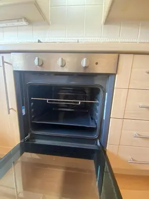 an oven with its door open in a kitchen at Modern central 2 bedroom flat with private parking in Glasgow