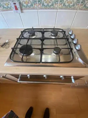 a stove top oven sitting on top of a counter at Modern central 2 bedroom flat with private parking in Glasgow