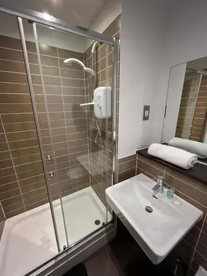 a bathroom with a shower and a sink at City centre stylish apartment in Glasgow
