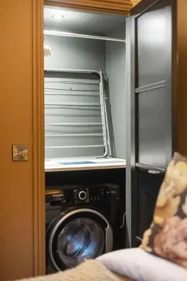 a washer and dryer inside of a closet at Boutique Studio Near Stirling in Cambusbarron
