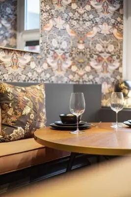 a table with two wine glasses on top of it at Boutique Studio Near Stirling in Cambusbarron