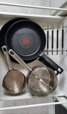 a pan and utensils on a shelf in a kitchen at Stylish, Modern 3 bedroom house, free parking x 2 in Mansewood