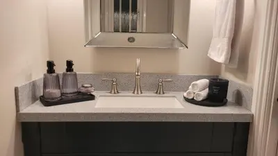 a bathroom counter with a sink and a mirror at Stylish, Modern 3 bedroom house, free parking x 2 in Mansewood